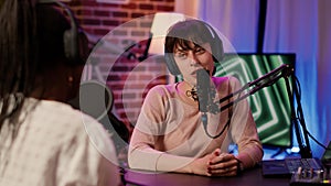 Selective focus on online radio host doing high five hand gesture with african american singer during live podcast