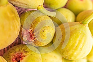 Selective focus of organically grown figs in a wicker basket, close-up view