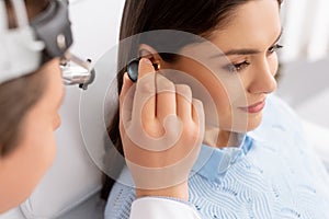 Focus of otolaryngologist examining ear of