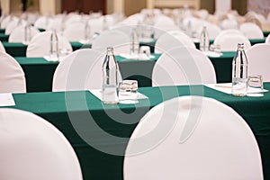 Selective focus of Paper, pencil, water bottle, glass  on the table in the seminar room background