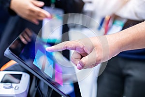 Selective focus of patient's hand touching tablet screen to check his or her health on health monitor using latest modern