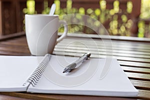 Selective focus of Pen, notebook , coffee cup on the wooden table and copy space