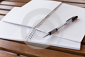 Selective focus of Pen, notebook on the wooden table and copy space