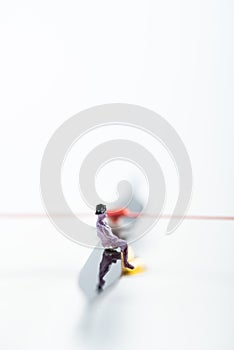 Selective focus of people figure on arrow of clock on white background with copy space