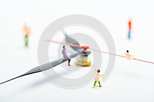 Selective focus of people figures near arrows of watch on white background photo