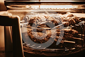 Selective focus photo of home grilling. cooking lulia-kebab minced mutton shashlyk on the air grill convection oven