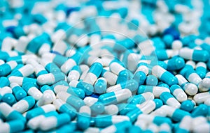 Selective focus on pile of blue and white antibiotic capsule pill. Pharmaceutical production. Global healthcare. Antibiotics drug