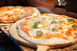 Selective focus of pizza in wood tray on the buffet table