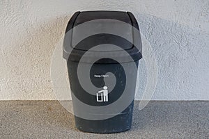 Selective focus public black plastic bin for garbage