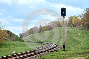 Selective focus railway green lantern of semaphore railroad enable, allow permit track that twists and turns between