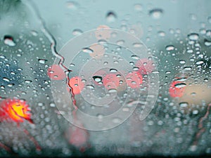 Selective focus of rain on the windshield of a car on a rainy day