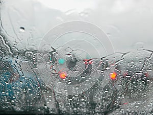 Selective focus of rain on the windshield of a car on a rainy day - driver`s perspective