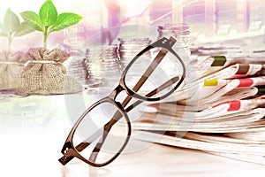 selective focus on reading eyeglasses with stacking of newspaper