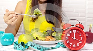 Selective focus of Red clcok which young woman Eating healthy breakfast for Intermittent fasting program for diet plan-Healthy