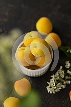 Selective focus: ripe fresh apricots in a clay bowl