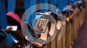 Selective focus of rusty metallic locks on a love bridge in Ukraine