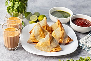 selective focus Samosa, Spiced potato-filled pastry, crispy, Savory, popular Indian snack with tomato and mint chutney.