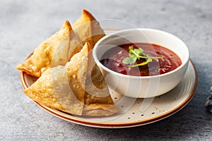 selective focus Samosa, Spiced potato-filled pastry, crispy, Savory, popular Indian snack with tomato and mint chutney.