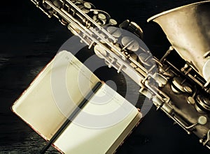 Selective focus on saxophone and open notebook