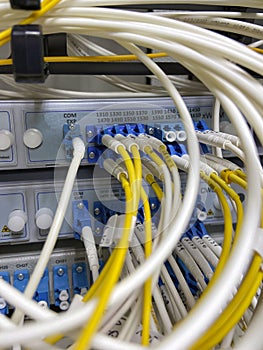 Selective focus server rack with fiber optic cables connected to front panel switch ports