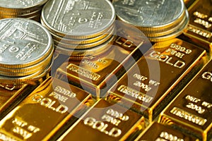selective focus on shiny gold bars with stack of coins as business or financial investment and wealth concept