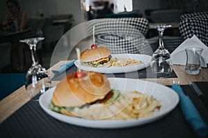 Selective focus shot of burger with french fries in a restaurant