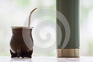 Selective focus shot of a calabash mate cup with straw - yerba mate tea infusion