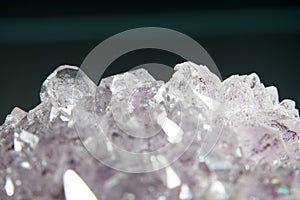 Selective focus shot of a cluster of quartz crystals on the black background