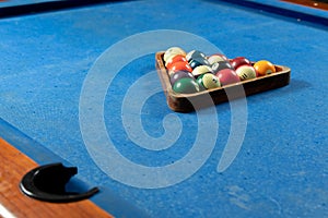 Selective focus shot of colorful billiard balls on pool blue table