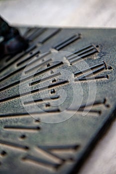 Selective focus shot of the details of a metal sundial
