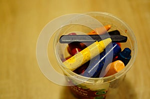 Selective focus shot of different color crayons in a plastic jar