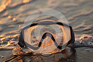 Selective focus shot of a diving goggle mask on a seashore