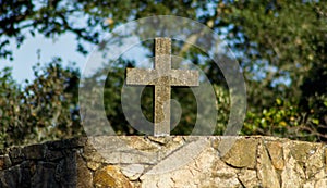 Selective focus shot of a gravestone cross