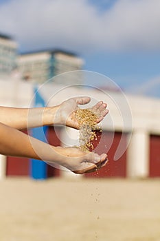 Selective focus shot of hands holding loose sand, Barceloneta Beach, Barcelona, Spain