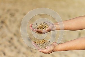 Selective focus shot of hands holding sand, Barceloneta Beach, Barcelona, Spain