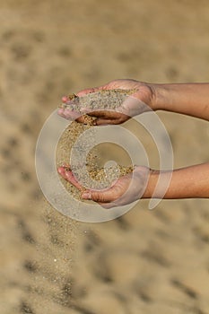 Selective focus shot of hands holding sand, Barceloneta Beach, Barcelona, Spain