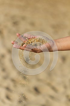Selective focus shot of hands holding sand, Barceloneta Beach, Barcelona, Spain