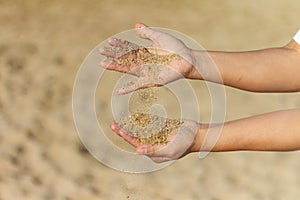 Selective focus shot of hands playing wi sand, Barceloneta Beach, Barcelona, Spain