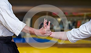 Selective focus shot of human hands showing Aikidoka during Aikido practice