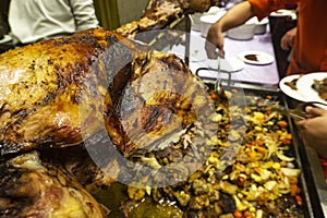 Selective focus shot image of whole lamb on skewer grilled