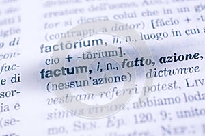 Selective focus shot of Latin factum word in a dictionary - translation: fact