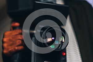 Selective focus shot of a male hand holding a camera