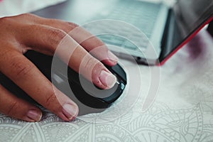 Selective focus shot of a male hand using a wireless computer mouse