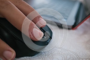 Selective focus shot of a male hand using a wireless computer mouse