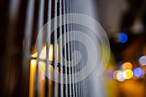 Selective focus shot of metal bars with blurred lights in the background