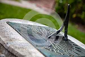 Selective focus shot of a metal sundial