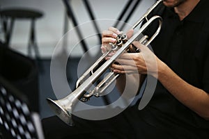 Selective focus shot of a person playing the trumpet