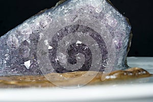 Selective focus shot of pure quartz crystal cluster isolated on black background