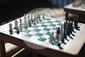 Selective focus shot of a set and arranged chess pieces on a board in the Republic of Cuba