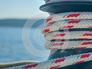 Selective focus shot of ship rope tied on a dock on blue background